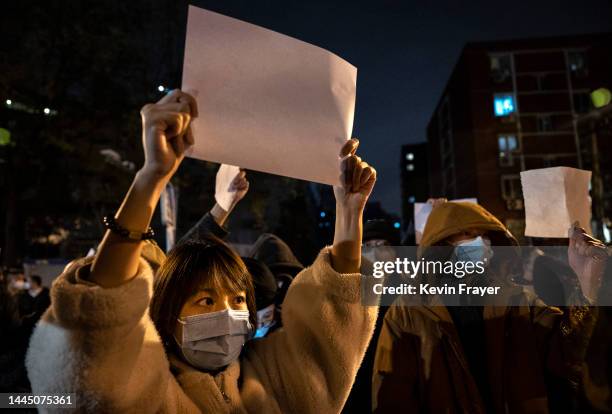 Protesters hold up pieces of paper against censorship and China's strict zero COVID measures on November 27, 2022 in Beijing, China. Protesters took...