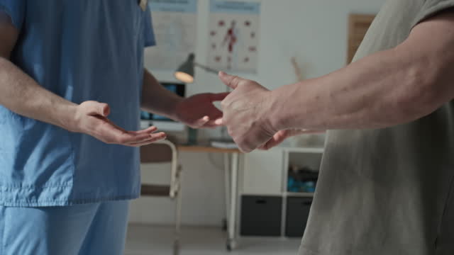 Patient Shaking Hands with Doctor at Hospital