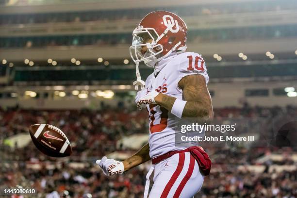 Wide receiver Theo Wease of the Oklahoma Sooners tosses the ball after running for a touchdown that is called back for a penalty during the first...