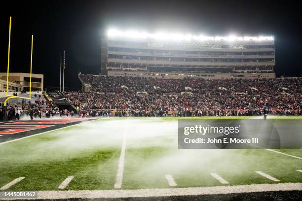 Fog blows across the field before the game between the Texas Tech Red Raiders and the Oklahoma Sooners at Jones AT&T Stadium on November 26, 2022 in...