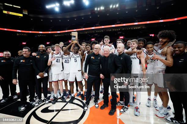 UConn Huskies basketball team pose with Nike founder Phil Knight after defeating the Iowa State Cyclones during the Phil Knight Invitational...