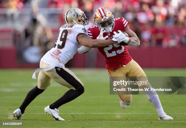 Elijah Mitchell of the San Francisco 49ers fights off the tackle of Chris Harris Jr. #19 o the New Orleans Saints during the second quarter of an NFL...