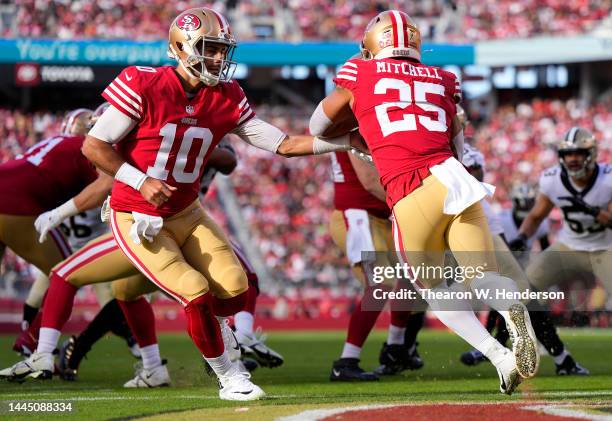 Elijah Mitchell of the San Francisco 49ers takes the handoff from quarterback Jimmy Garoppolo against the New Orleans Saints during the second...