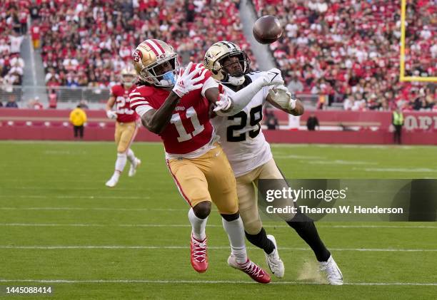 Paulson Adebo of the New Orleans Saints breaks up a pass intended for Brandon Aiyuk of the San Francisco 49ers during the third quarter at Levi's...