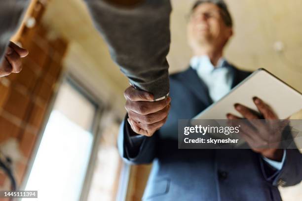 successful deal at construction site! - handshake closeup stock pictures, royalty-free photos & images