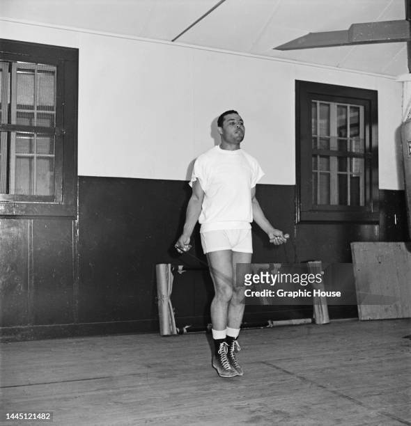 American heavyweight boxer Joe Louis , wearing white shorts and a white t-shirt, skipping during training at an gym in Pompton Lakes, New Jersey,...