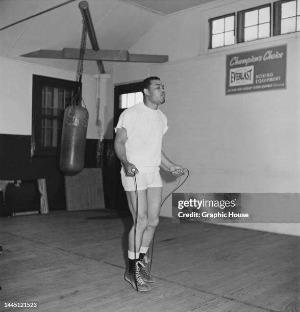 American heavyweight boxer Joe Louis , wearing white shorts and a white t-shirt, skipping during training at an gym in Pompton Lakes, New Jersey,...