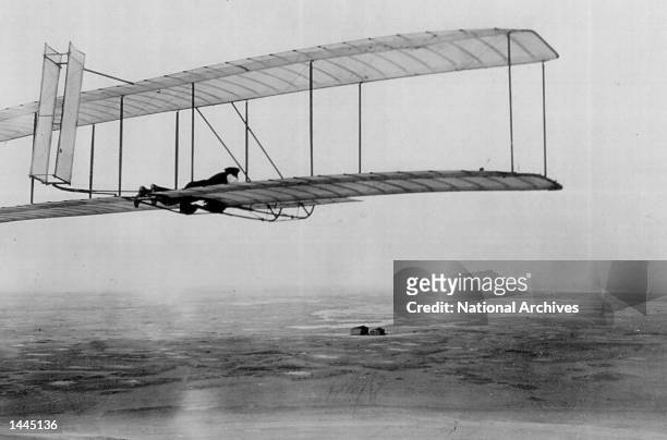 Orville Wright flies a glider with a movable double rear vertical rudder in Kitty Hawk, NC in 1903.