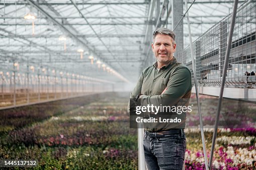 A male management owner in an Orchid Greenhouse in Holland