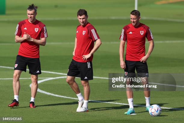 LrGareth Bale, Ben Davies and Chris Gunter of Wales look on during the Wales Training Session at Al Sadd Sports Club on November 28, 2022 in Doha,...