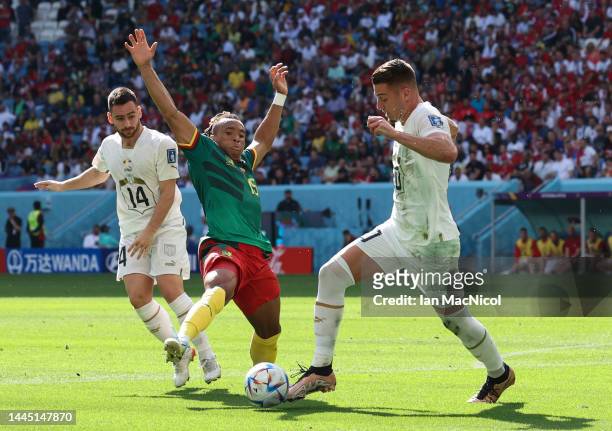 Pierre Kunde of Cameroon vies with Sergej Milinković-Savić of Serbia during the FIFA World Cup Qatar 2022 Group G match between Cameroon and Serbia...