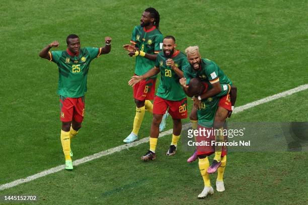 Eric Maxim Choupo-Moting of Cameroon celebrates with teammates after scoring their team's third goal during the FIFA World Cup Qatar 2022 Group G...