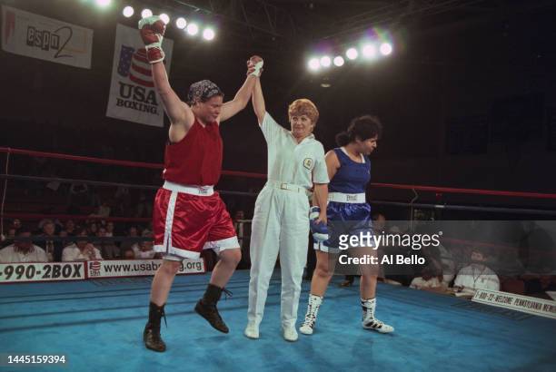 The referee raises the arms of Gigi Jackson after defeating Lisandra Velasquez in the 91kg Heavyweight title fight during the Everlast US National...