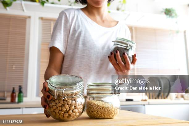 unrecognizable woman organising pantry. legumes and cereals in glass containers. shopping in bulk. zero waste. - well structure stock pictures, royalty-free photos & images