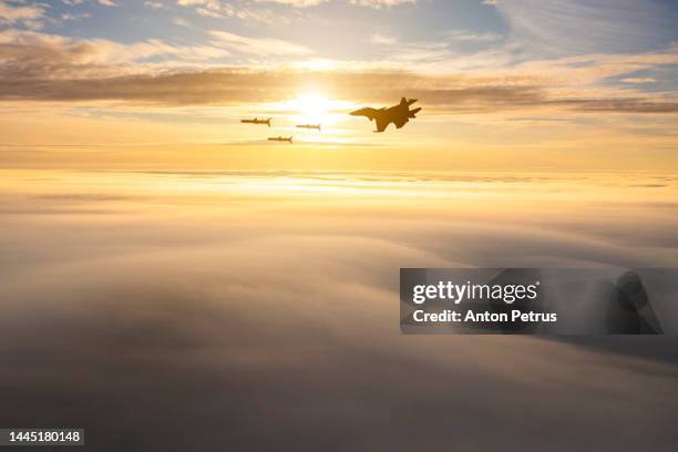 fighter aircraft launches cruise missiles at sunset - cruise missile stock pictures, royalty-free photos & images