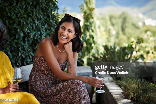 young woman with wineglass laughing in party - mittlerer teil stock-fotos und bilder