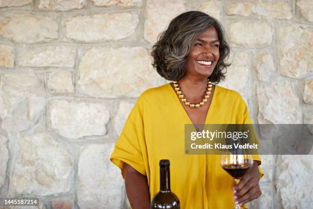 happy female owner holding wine glass and bottle - sommelier stock pictures, royalty-free photos & images