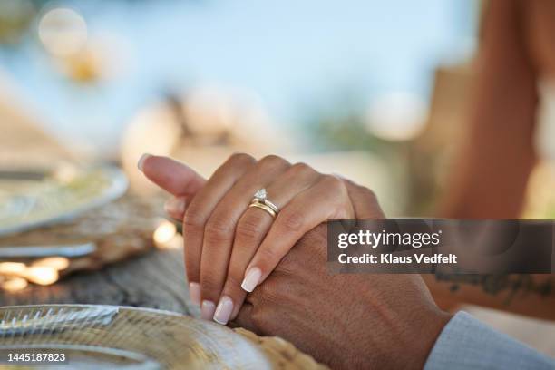 bride with wedding ring holding hand of groom - couple jewelry stockfoto's en -beelden