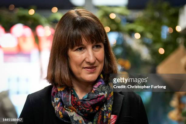 Labour's Shadow Chancellor of the Exchequer Rachel Reeves talks to business owners and members of the public during a visit to a green grocers in...
