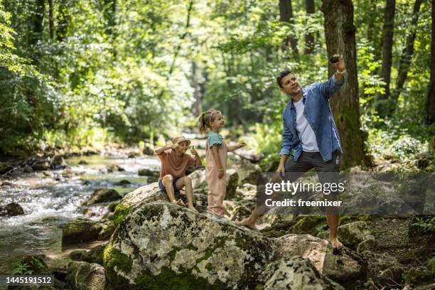 happy family taking selfie in nature - boy taking picture in forest stock pictures, royalty-free photos & images