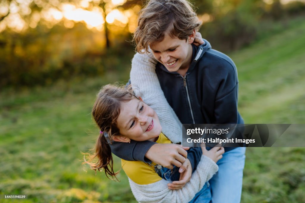 Isbling Fun Happy Siblings Having Fun At Meadow High-Res Stock Photo - Getty Images
