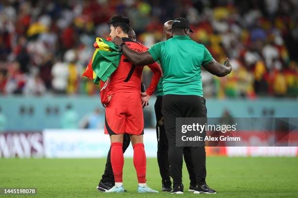 Ghana team officials holding a mobile phone interact with Heungmin Son of Korea Republic the FIFA World Cup Qatar 2022 Group H match between Korea...