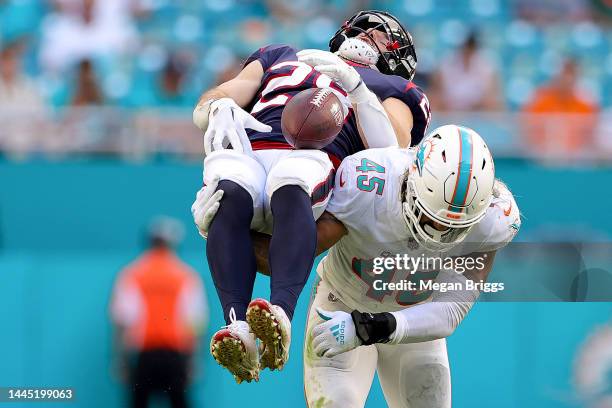 Duke Riley of the Miami Dolphins tackles Rex Burkhead of the Houston Texans during the fourth quarter at Hard Rock Stadium on November 27, 2022 in...