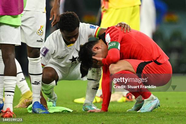 Heungmin Son of Korea Republic is consoled by Tariq Lamptey of Ghana after the FIFA World Cup Qatar 2022 Group H match between Korea Republic and...