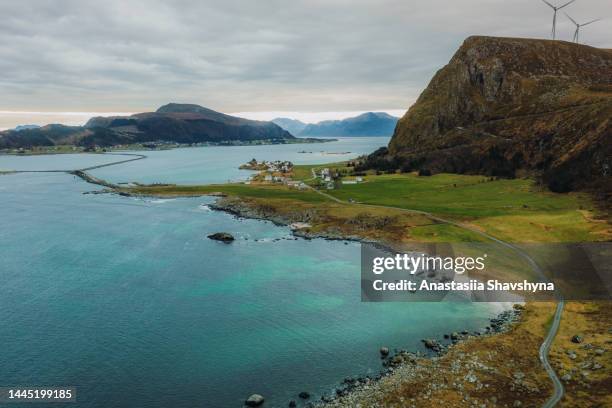 aerial view of the scenic bridge above emerald green sea between the islands with wind turbines in norway - romsdal in norway stockfoto's en -beelden