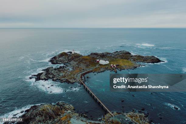 aerial view of the scenic remote island with the bridge and lighthouse surrounded by waves in norway - romsdal stock pictures, royalty-free photos & images