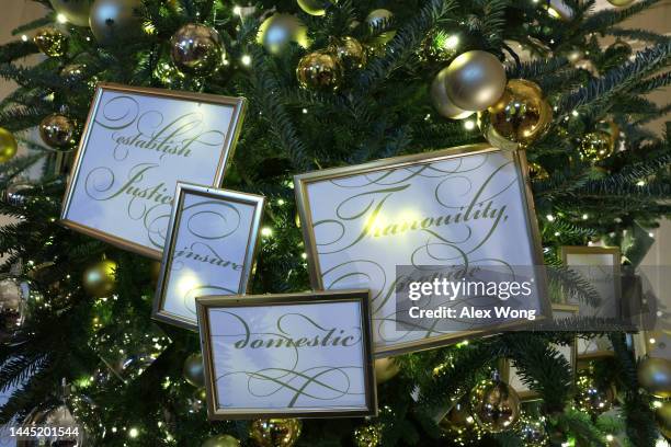 Ornaments are hung on a Christmas tree at the White House during a press preview of the holiday décor on November 28, 2022 in Washington, DC. The...