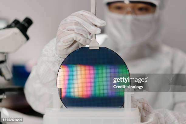 chip engineer is taking wafer out from box - nanotechnologie photos et images de collection