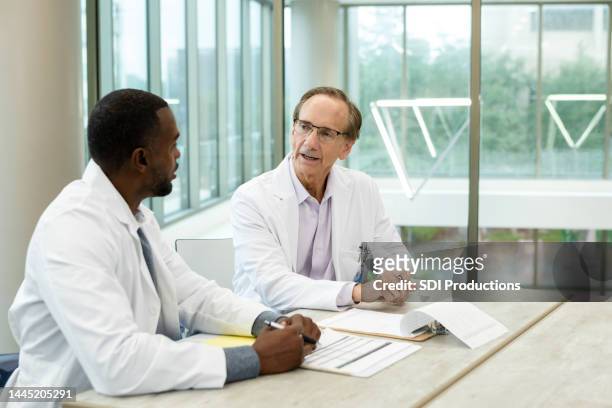 two physicians meet - case studies stock pictures, royalty-free photos & images