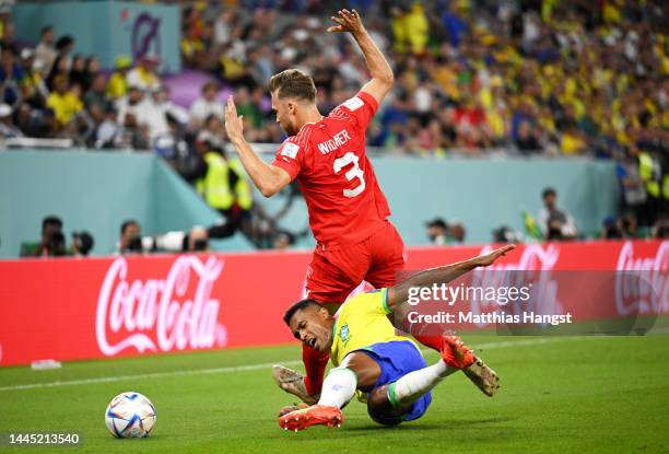 Alex Sandro of Brazil is challenged by Silvan Widmer of Switzerland during the FIFA World Cup Qatar 2022 Group G match between Brazil and Switzerland...