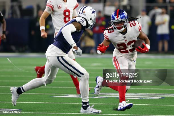 Trevon Diggs of the Dallas Cowboys moves to tackle Gary Brightwell of the New York Giants at AT&T Stadium on November 24, 2022 in Arlington, Texas.