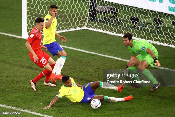 Alex Sandro and Alisson Becker of Brazil defend the ball against Fabian Rieder of Switzerland during the FIFA World Cup Qatar 2022 Group G match...