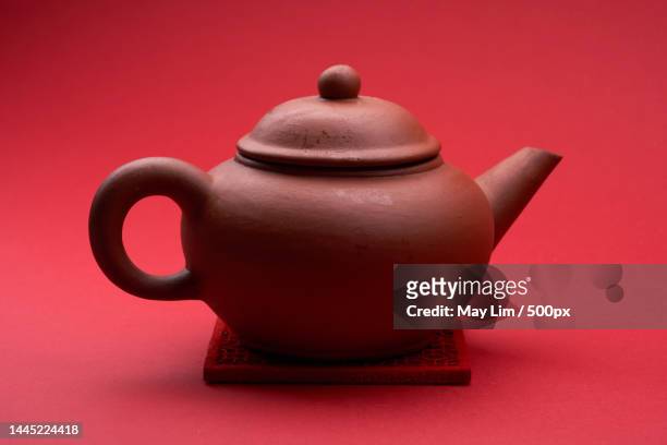 close up of the traditional tea pot against red background,malaysia - pour spout stock pictures, royalty-free photos & images