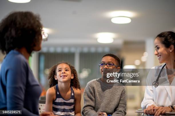 family goes for medical consultation - sibling hospital stock pictures, royalty-free photos & images