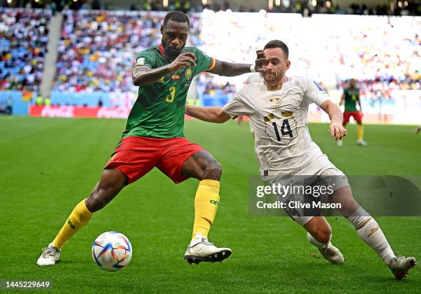 Nicolas Nkoulou of Cameroon controls the ball under pressure of Andrija Zivkovic of Serbia during the FIFA World Cup Qatar 2022 Group G match between...