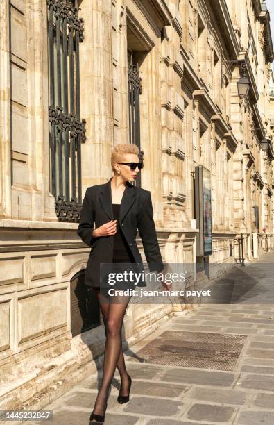 paris, france - portrait of a young woman walking in a street - strumpfwaren stock-fotos und bilder