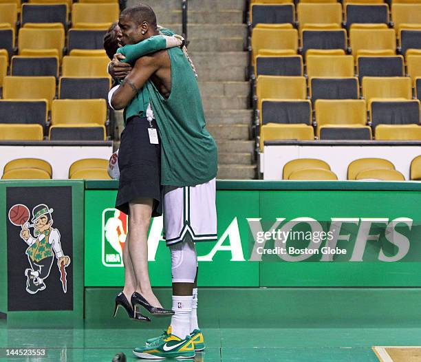 The Celtics 6'6" Mickael Pietrus lifts Laura Bakun, who works as a senior coordinator in Celtics Corporate Partnerships, as he gives her a playful...