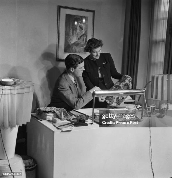 British fashion designer Norman Hartnell , examining a fabric sample, London, January 1945. Original publication: Picture Post - 1866 - London: Can...