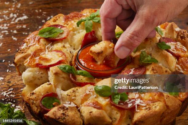 pepperoni pizza pull apart monkey bread - pulling apart stock pictures, royalty-free photos & images