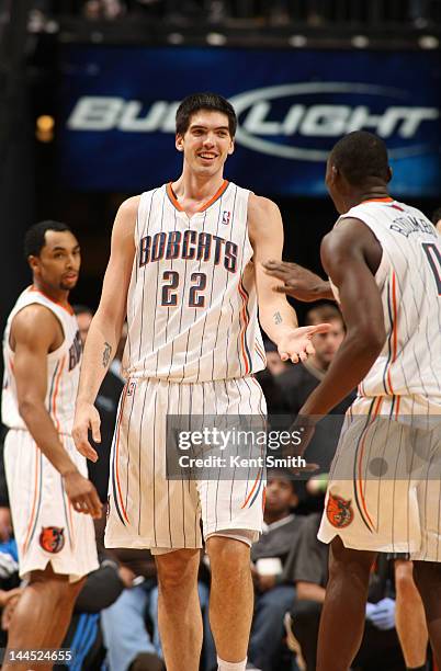 Byron Mullens of the Charlotte Bobcats is congratulated by teammate Bismack Biyombo after a basket during the game against the Orlando Magic at the...