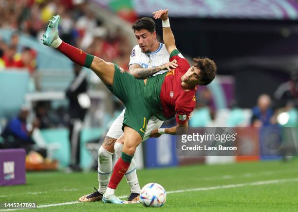 Joao Felix of Portugal battles for possession with Jose Maria Gimenez of Uruguay during the FIFA World Cup Qatar 2022 Group H match between Portugal...