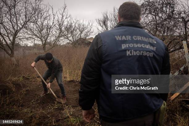 Local resident helps police, forensic experts and war crimes prosecution teams to exhume a burial site containing the bodies of six civilians that...