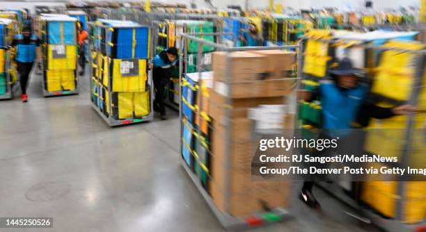Packages come and go during Cyber Monday at an Amazon Distribution Facility on November 28, 2022 in Aurora, Colorado. Amazon has introduced electric...