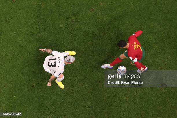 Cristiano Ronaldo of Portugal takes on Guillermo Varela of Uruguay during the FIFA World Cup Qatar 2022 Group H match between Portugal and Uruguay at...