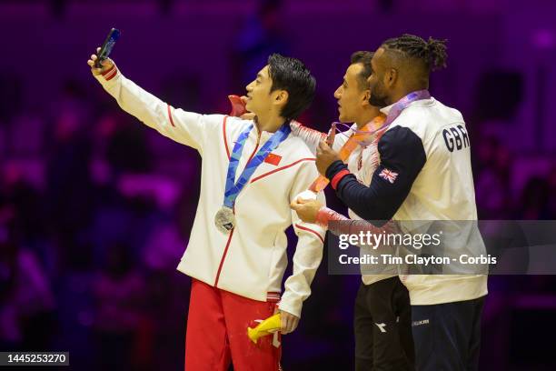 November 5: Silver medal winner Jingyuan Zou of China takes a selfie with gold medal winner Adem Asil of Turkey and bronze medal winner Courtney...