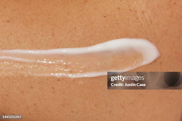 close up of lotion on skin - body lotion stock-fotos und bilder